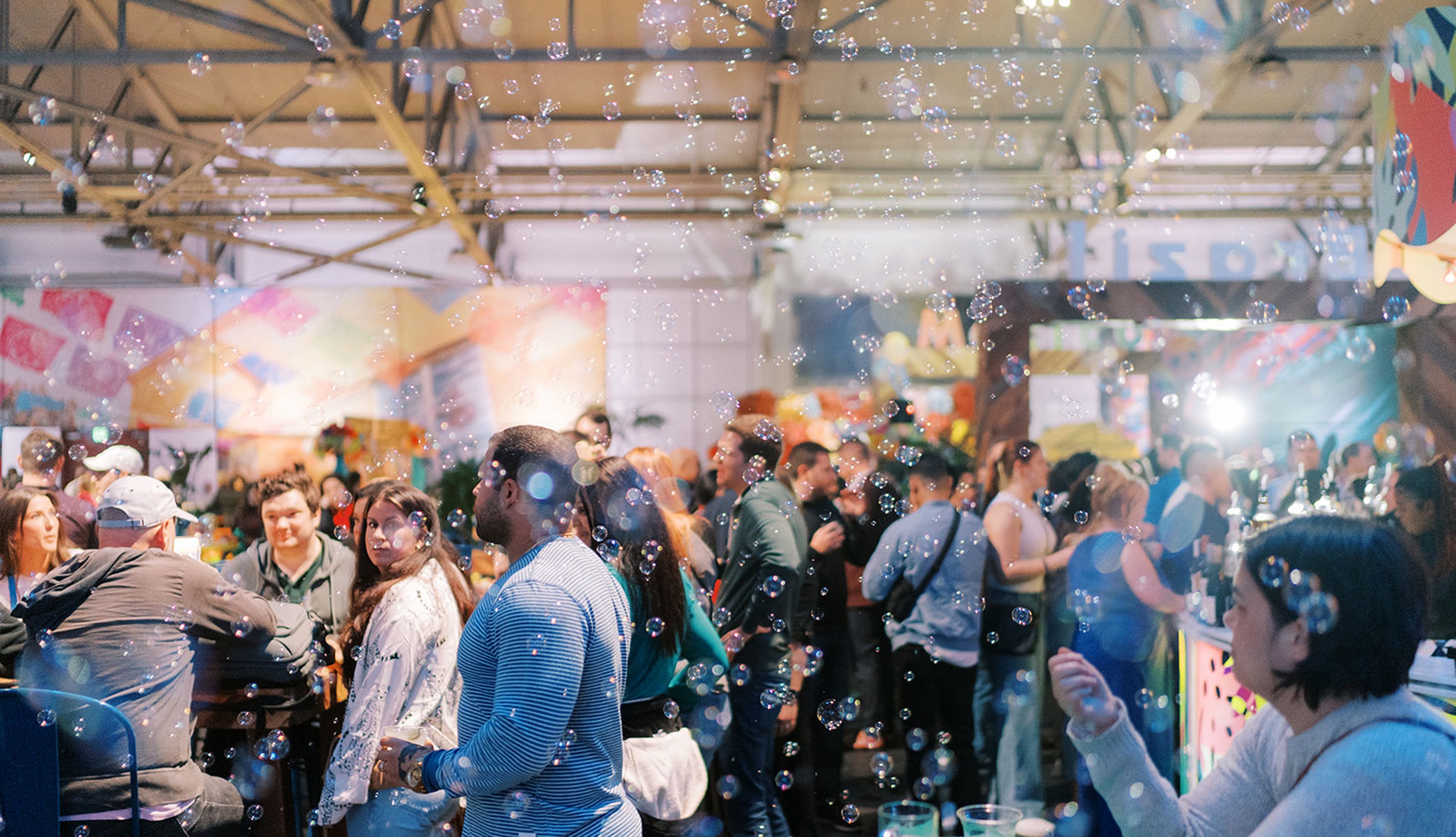 Guests participating in an interactive team building event with bubbles