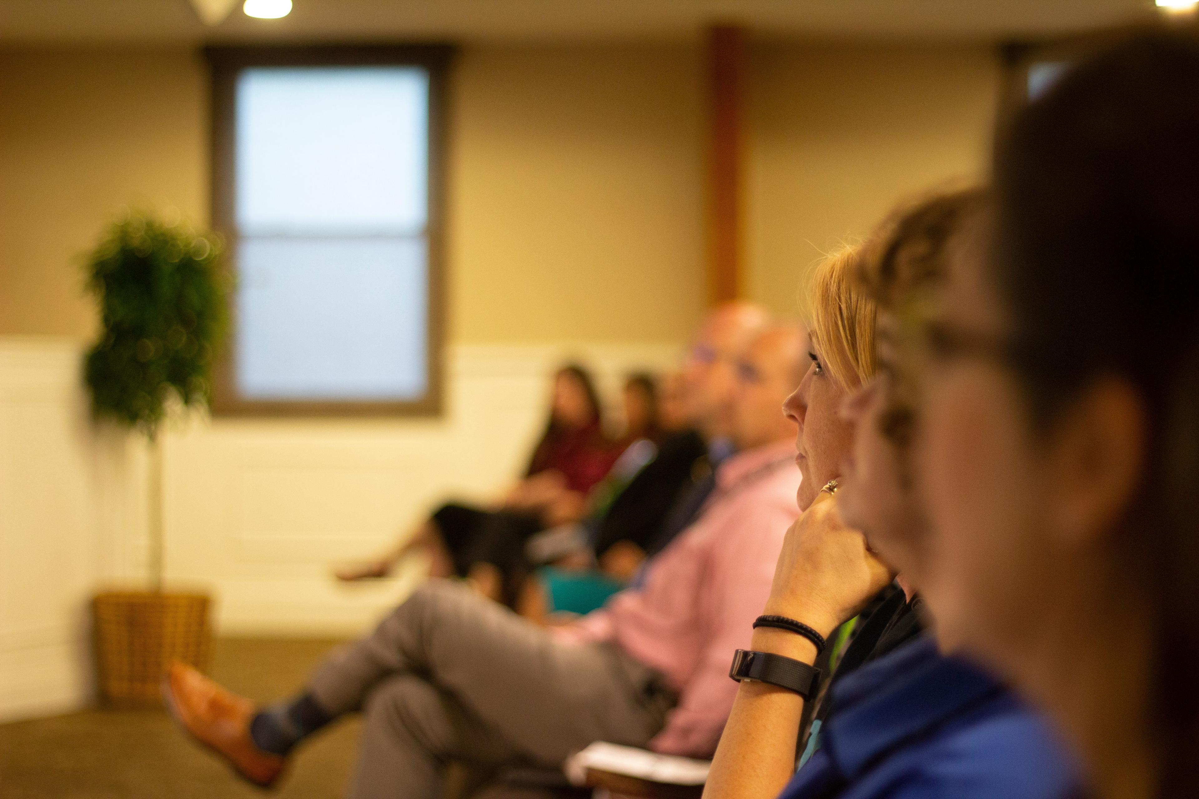 A row of people seated and listening