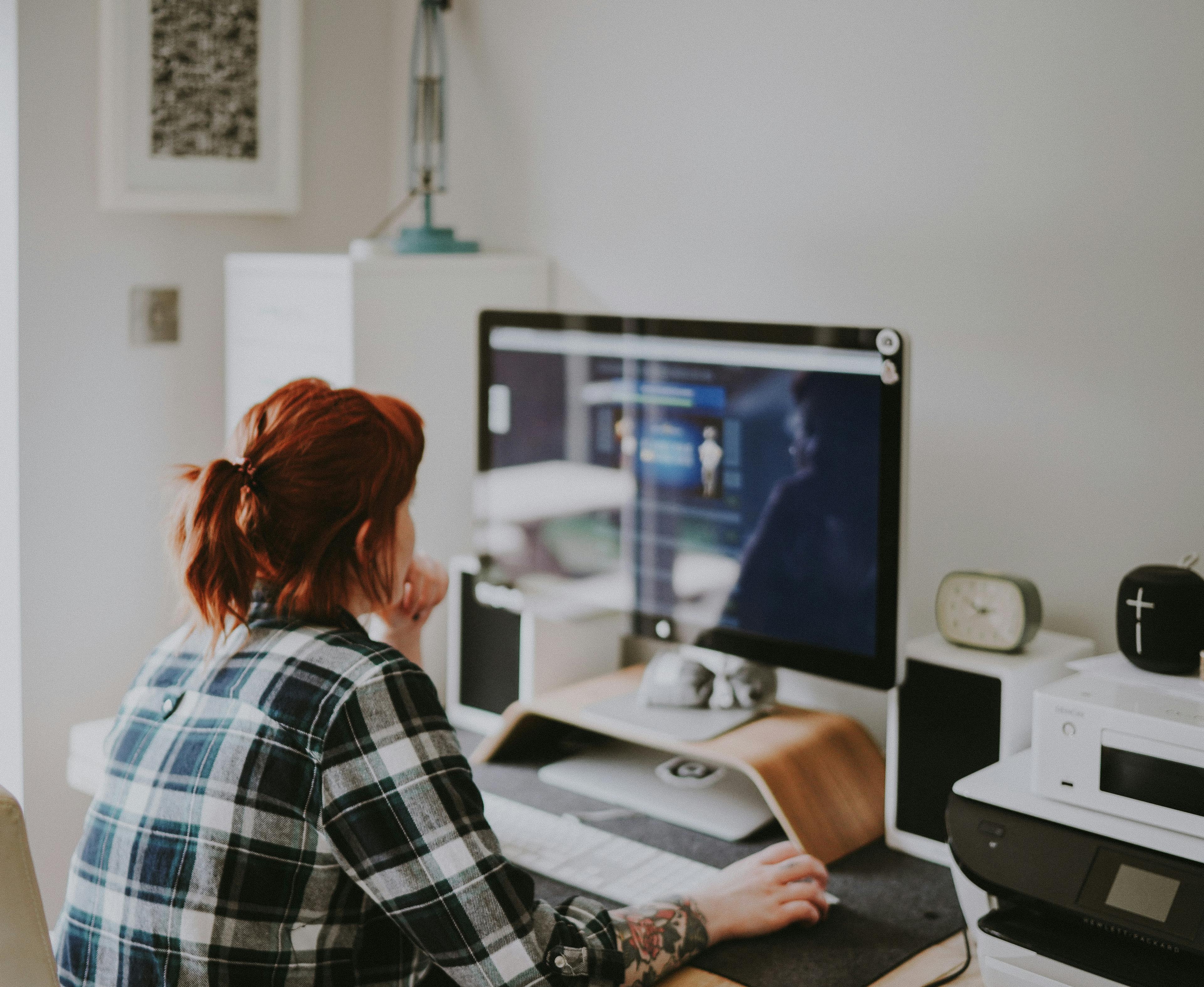 A woman sitting at a desk in front of a computer