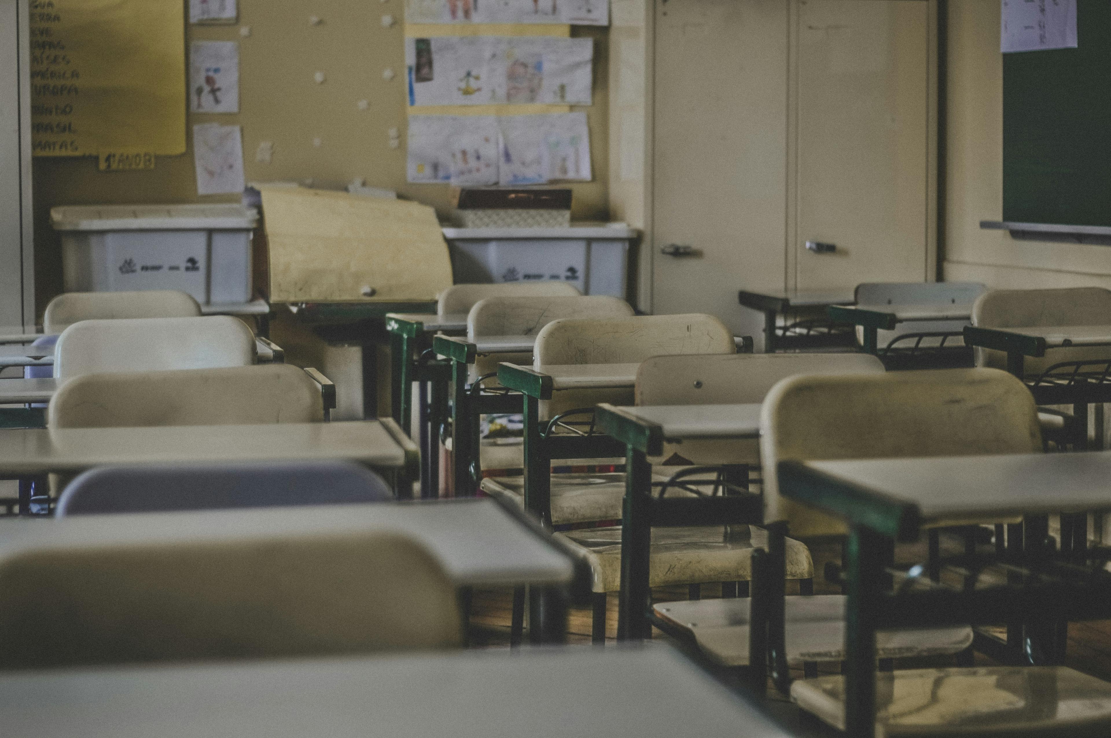 An empty classroom with desks and chairs