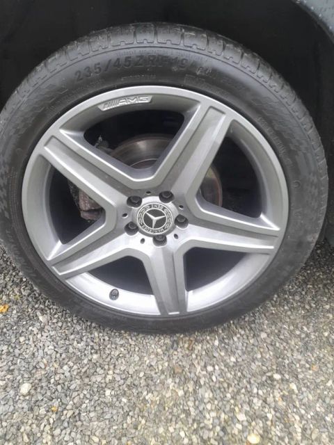 A grey Mercedes-AMG five-spoke wheel