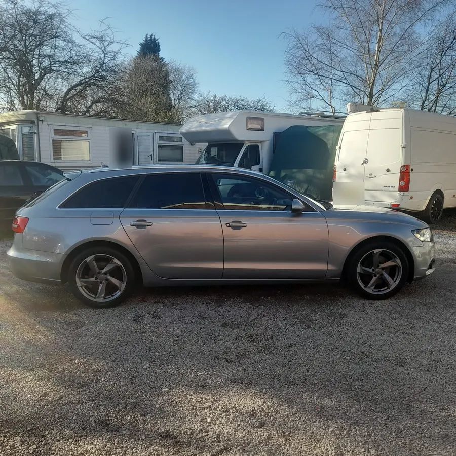 A silver Audi estate on grey five-spoke wheels, on the yard