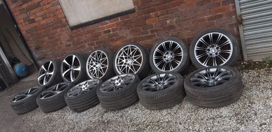 A set of refurbished wheels lined up against the brick wall