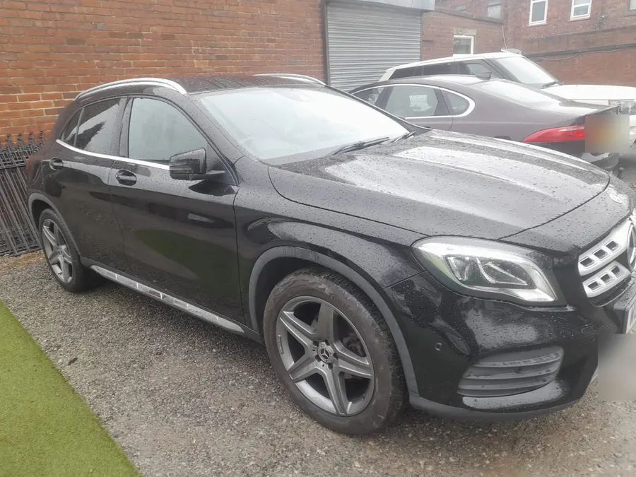A black Mercedes GLA on grey AMG wheels