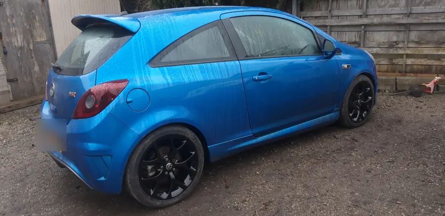 A blue Vauxhall Corsa on gloss black wheels