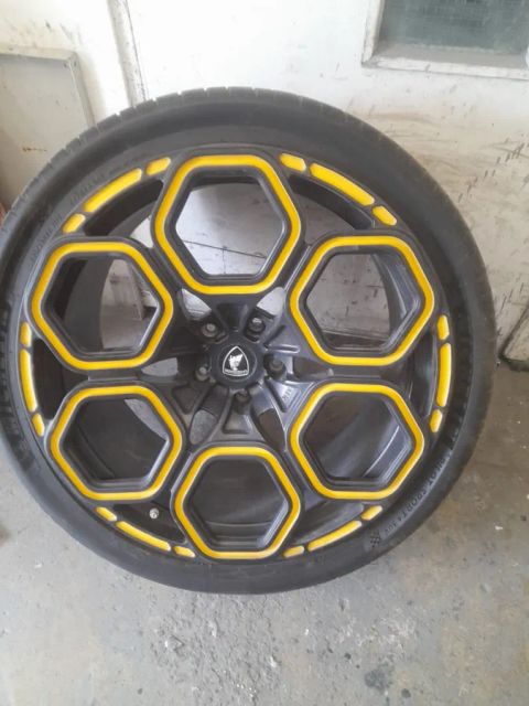 A black wheel with yellow hexagon outlines on the spokes