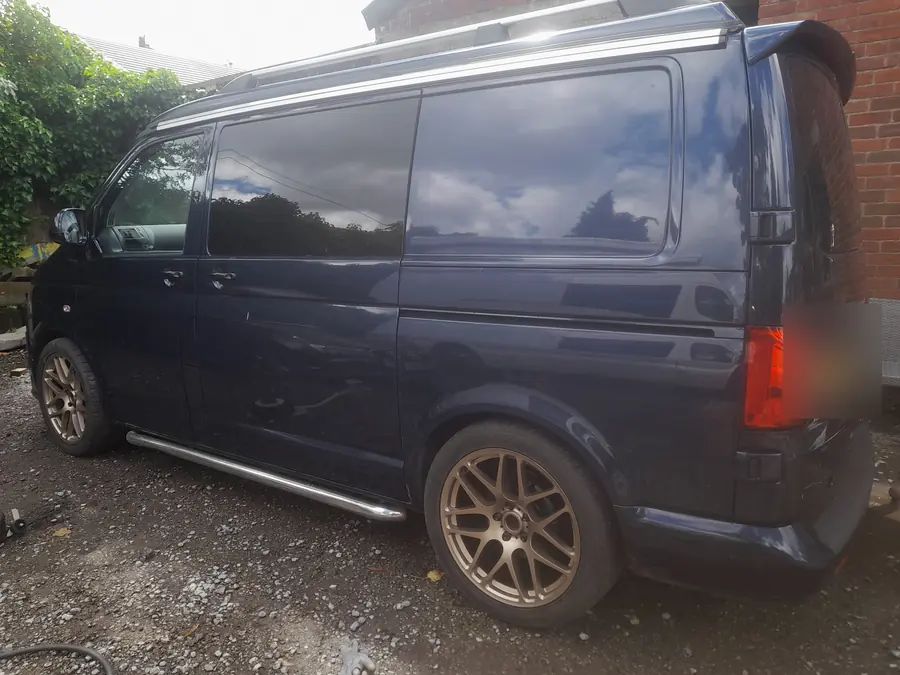 A navy VW Transporter on bronze wheels