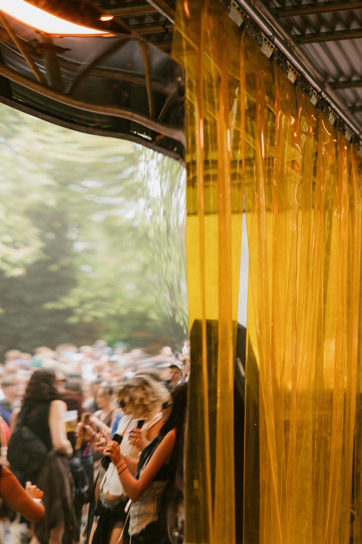 Photograph a light in the trees under a stage at Rally festival in 2025