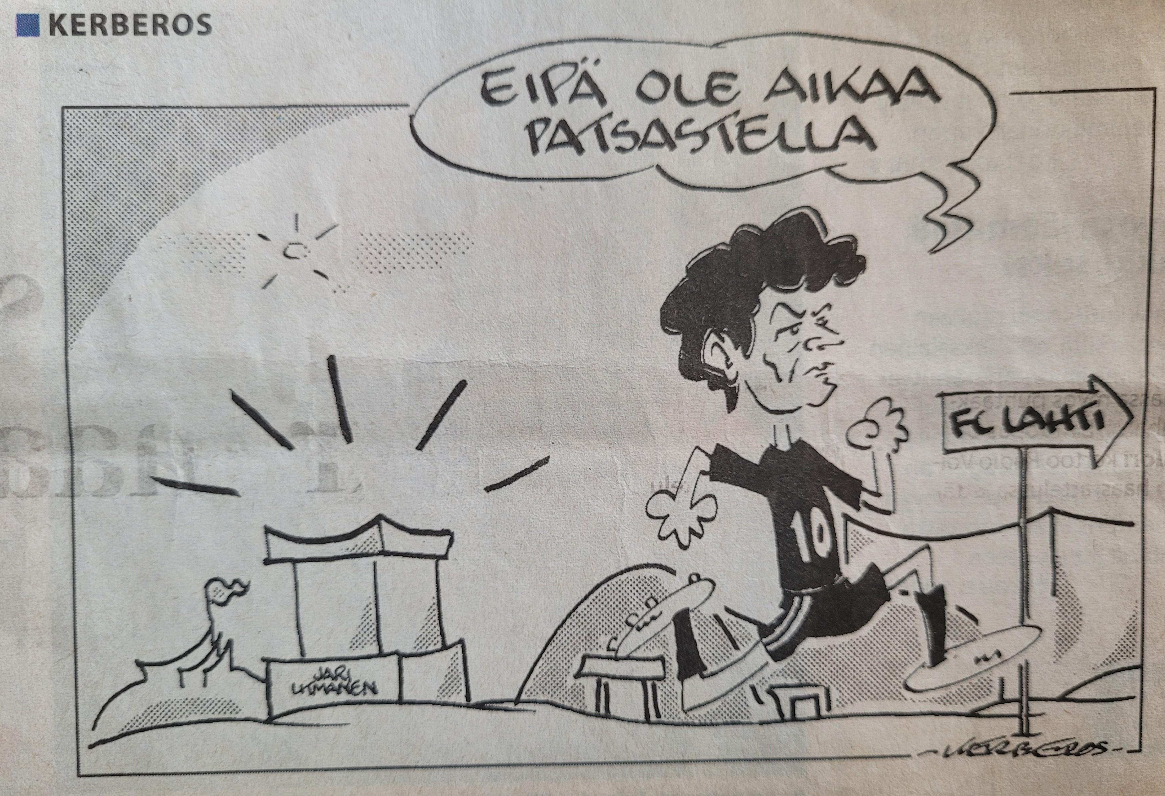 Kerberos-pilapiirros: Jari Litmanen juoksee patsaansa ohi kohti FC Lahti -kylttiä, puhekuplassa ”Eipä ole aikaa patsastella”