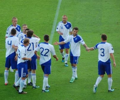 Huuhkajat juhlivat maalia valkoisissa peliasuissa kentällä, 02.09.2011