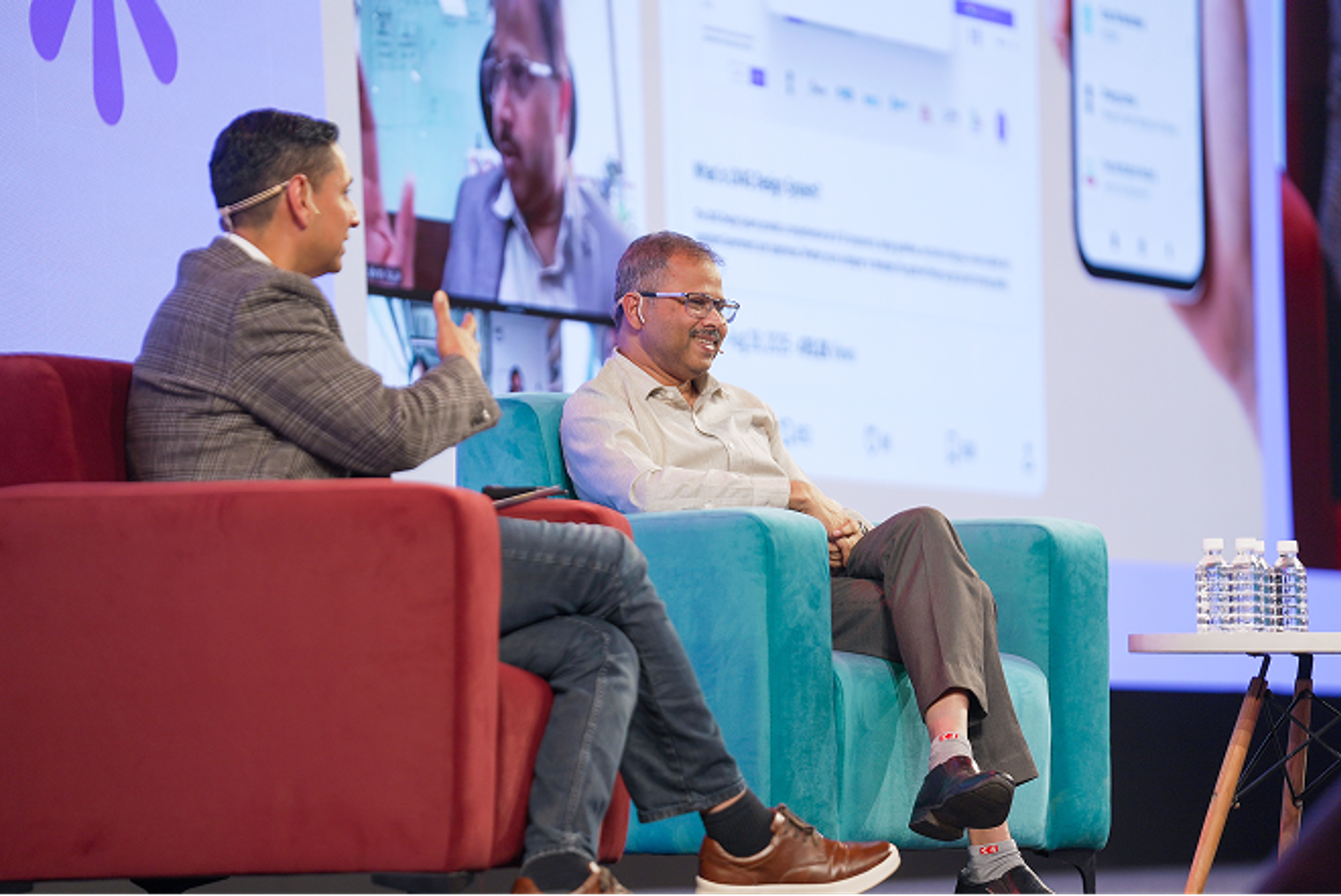 Two male speakers in conversation on stage at Config