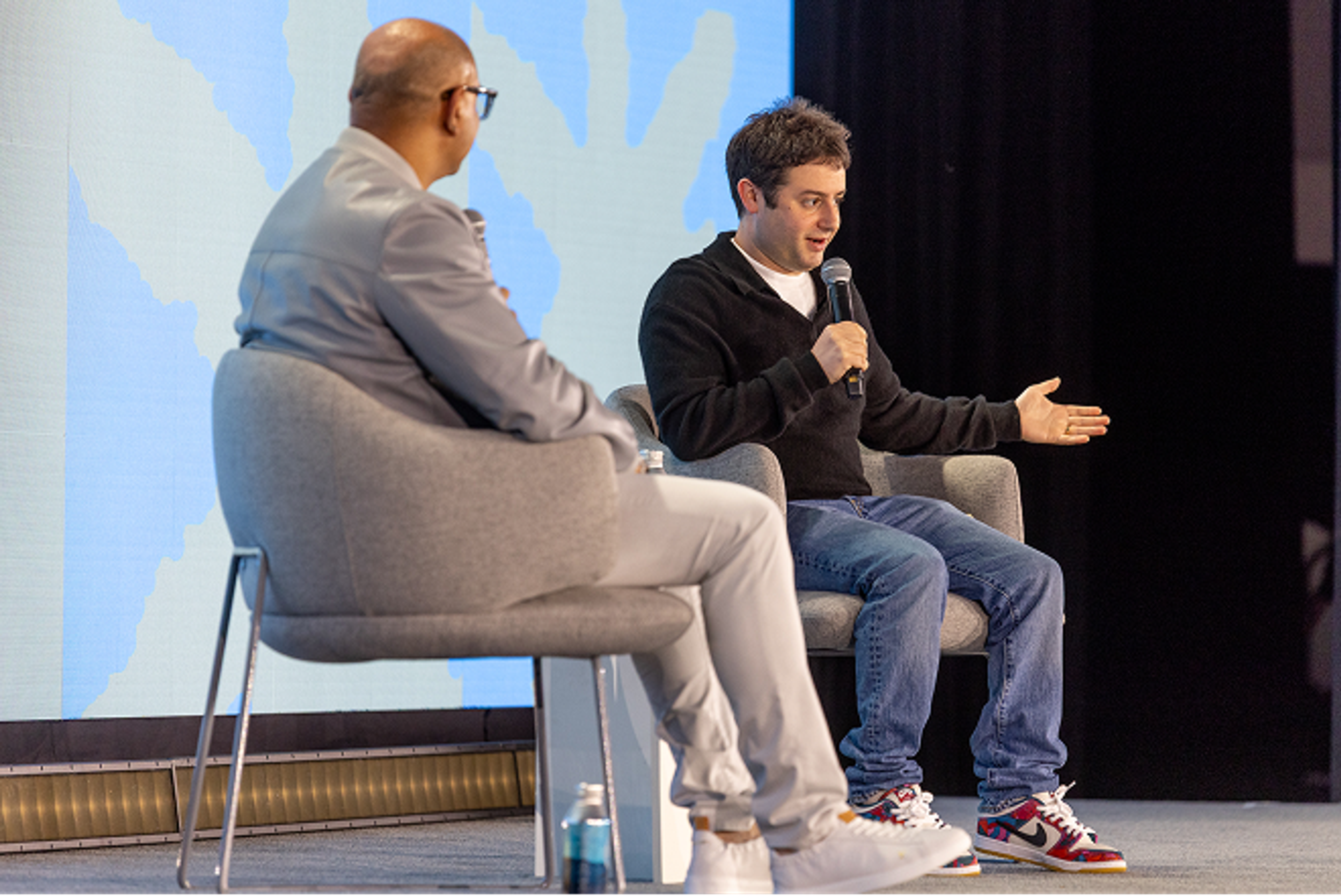 Dylan and speaker on stage at Config in conversation