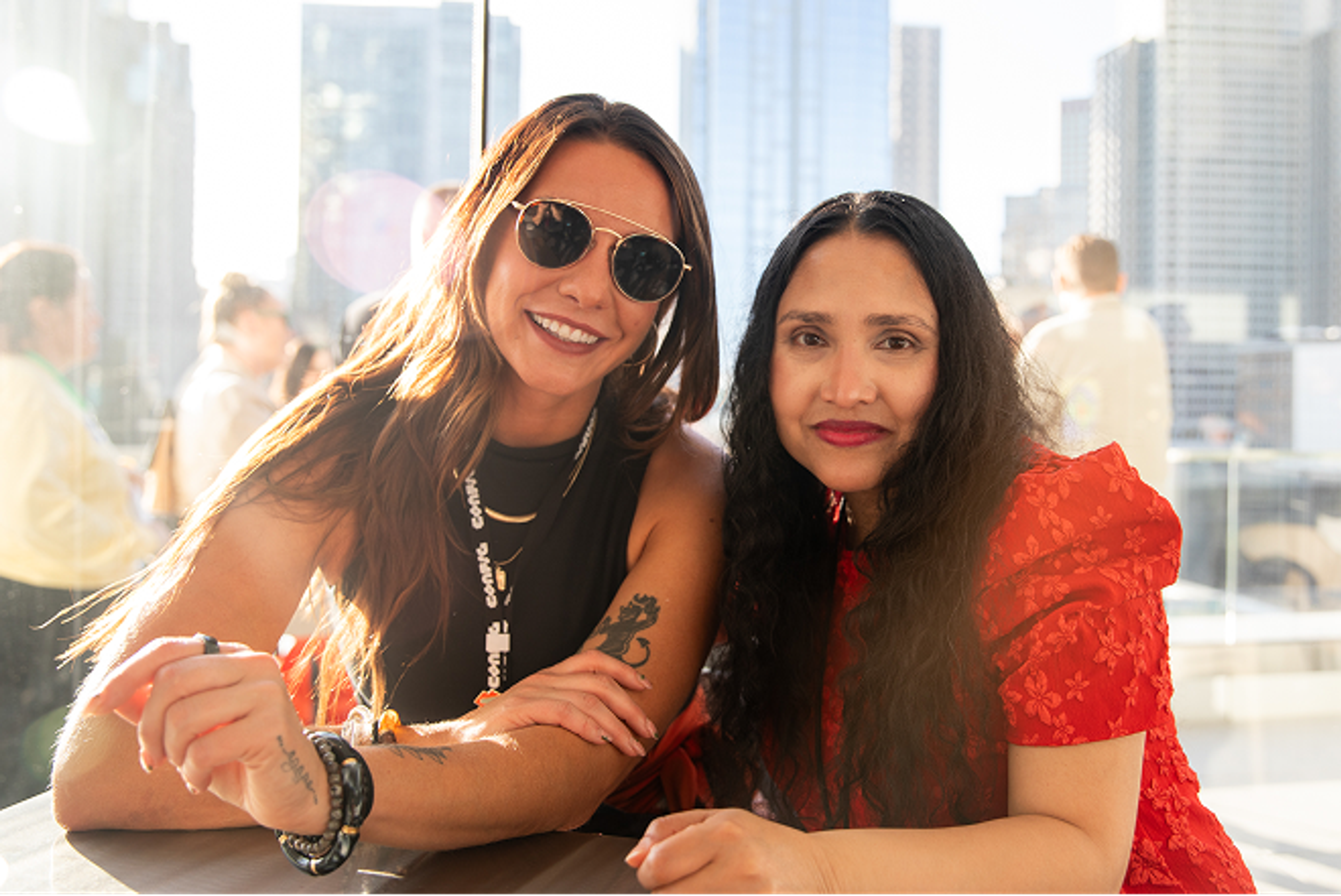 Two women smiling sitting at a table