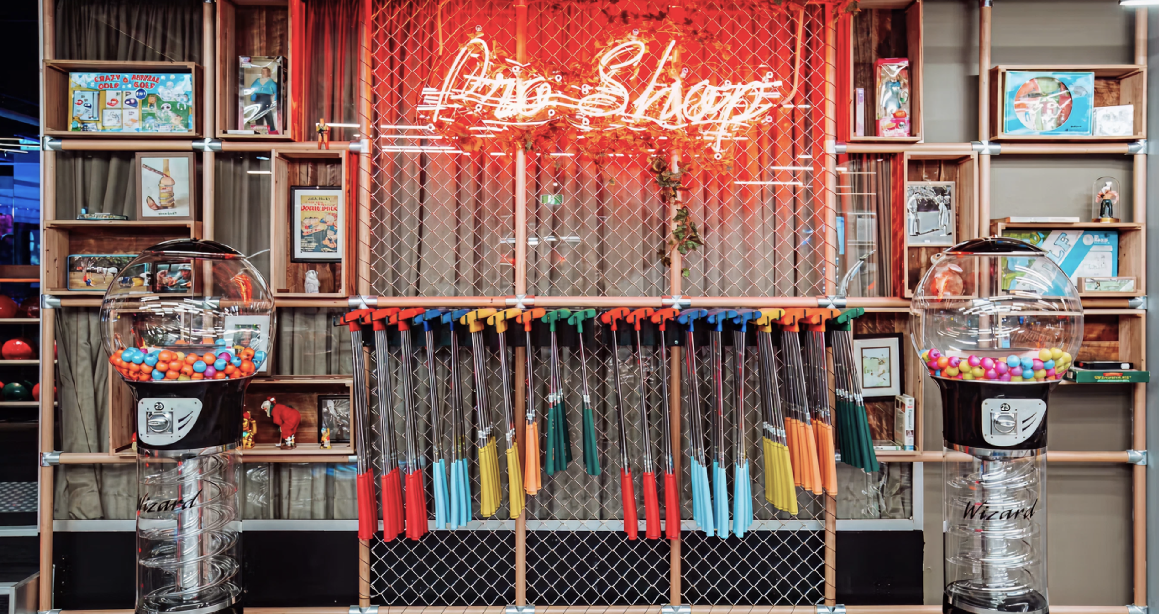 Golf clubs hung on a wall for retro-fit mini golf course