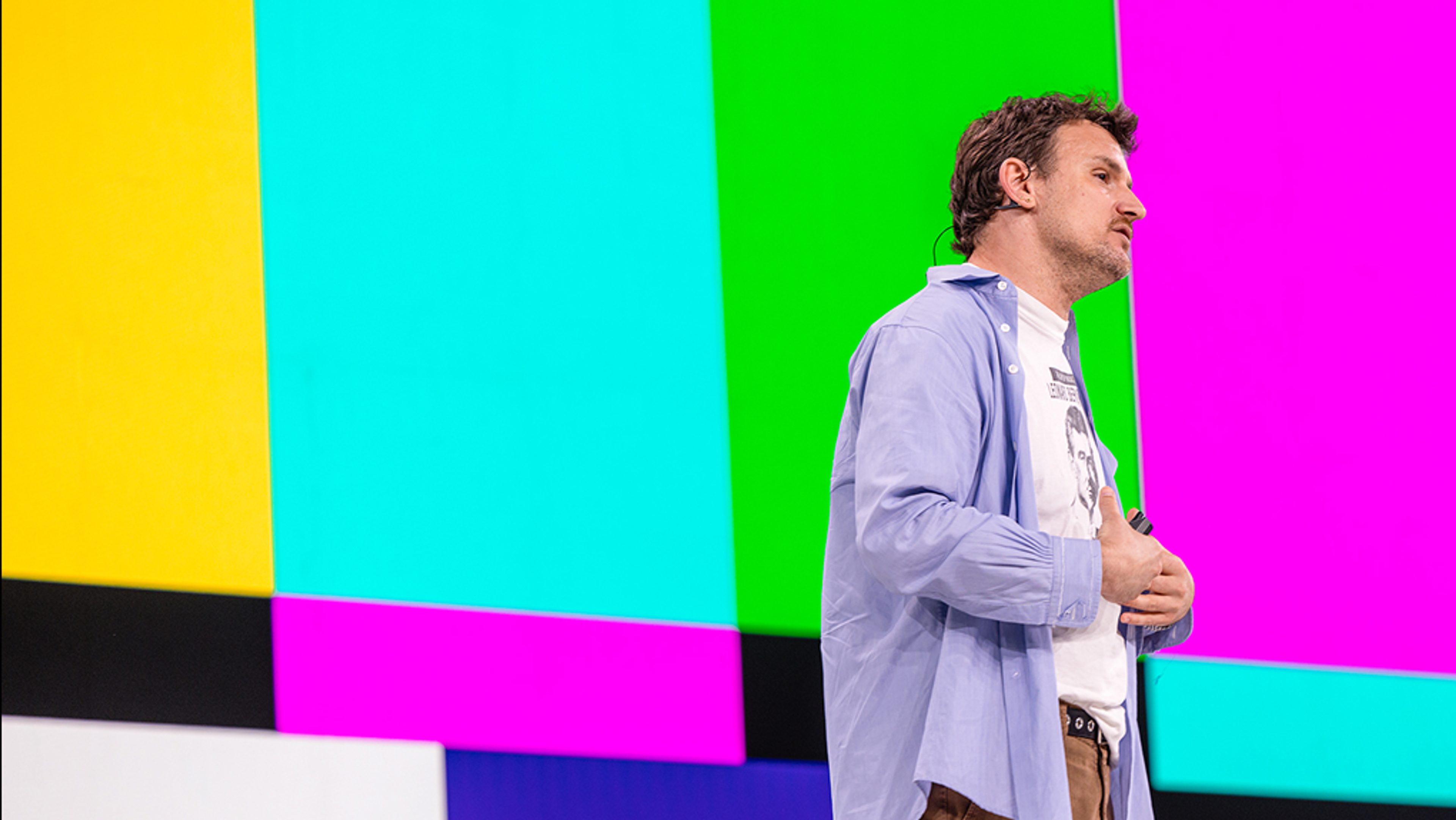 Brent speaking with colorful tv screen background