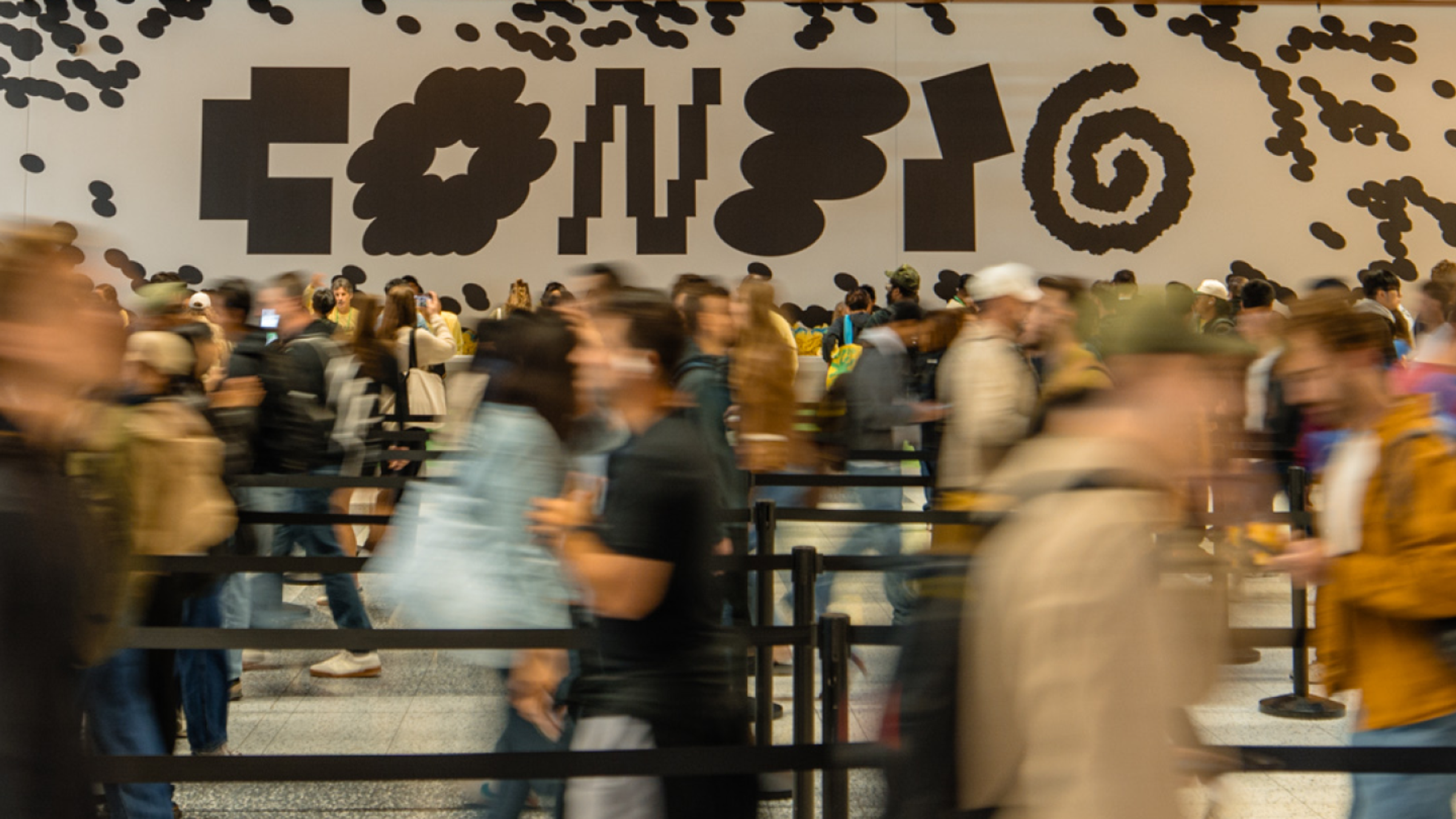 Motion photo of people walking through Config