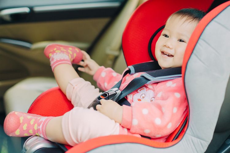 Can my child wear a coat in their car seat?