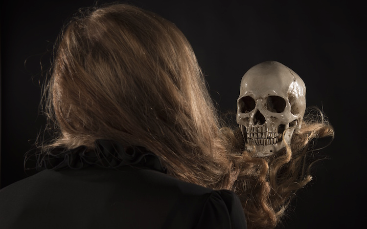 woman looking at her skull