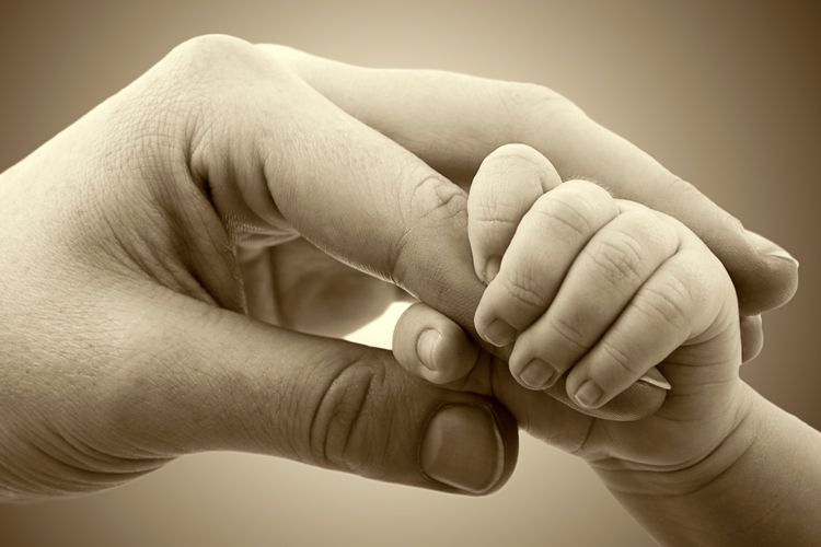 baby hand holding mommy's finger