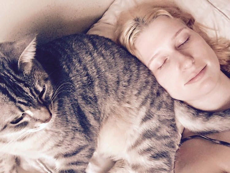 woman using cat as pillow