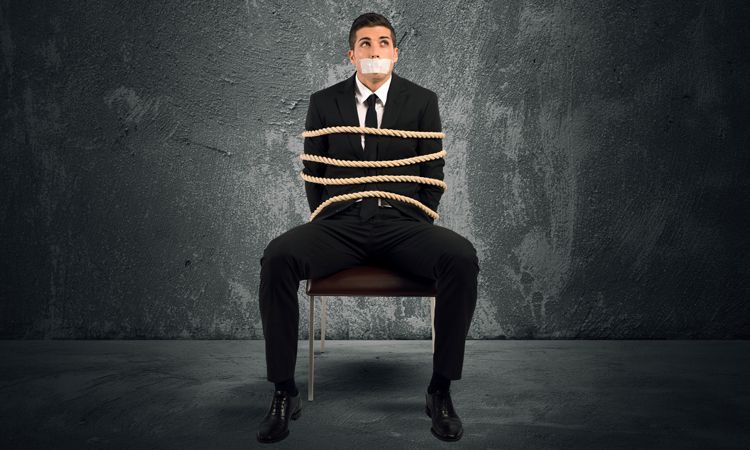 businessman tied to a chair