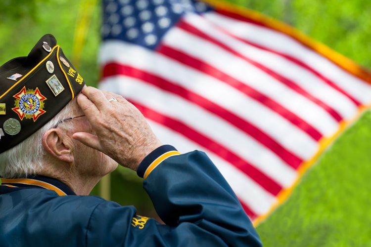 military veteran saluting flag