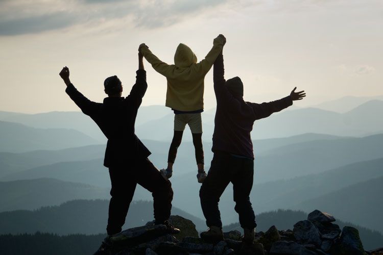 triumphant family on top of a mountain