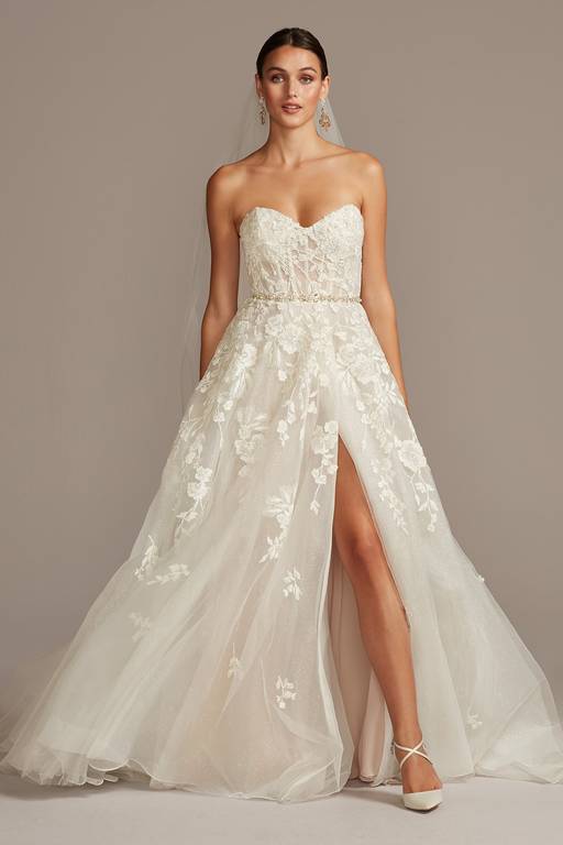 davids bridal dress David's Floral Tulle Wedding Size 18W and the look is finished with a hidden skirt slit. David's Bridal - is it