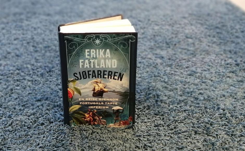 Boka Sjøfareren av Erika Fatland stående på et blått teppe