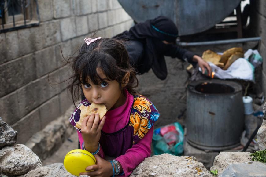 Jente spiser brød i Jemen