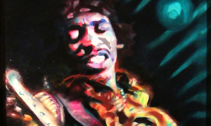 Jimi Hendrix på scenen med gitar